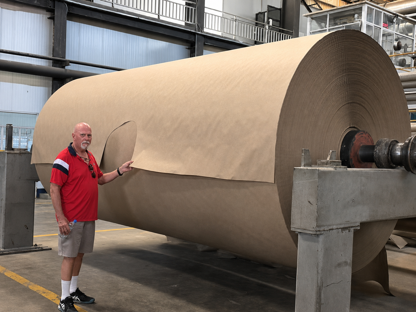 P’ZAZZZ factory inspection of a finished roll of post-consumer recycled paper